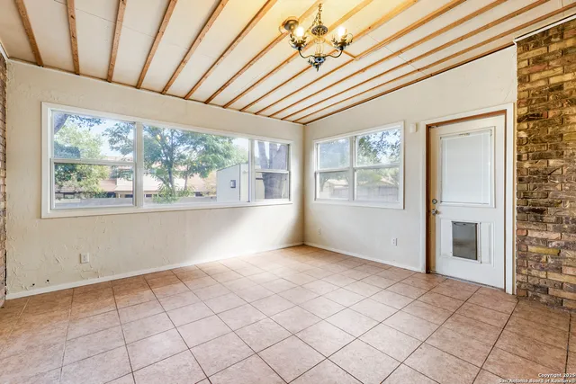a view of an empty room with a window