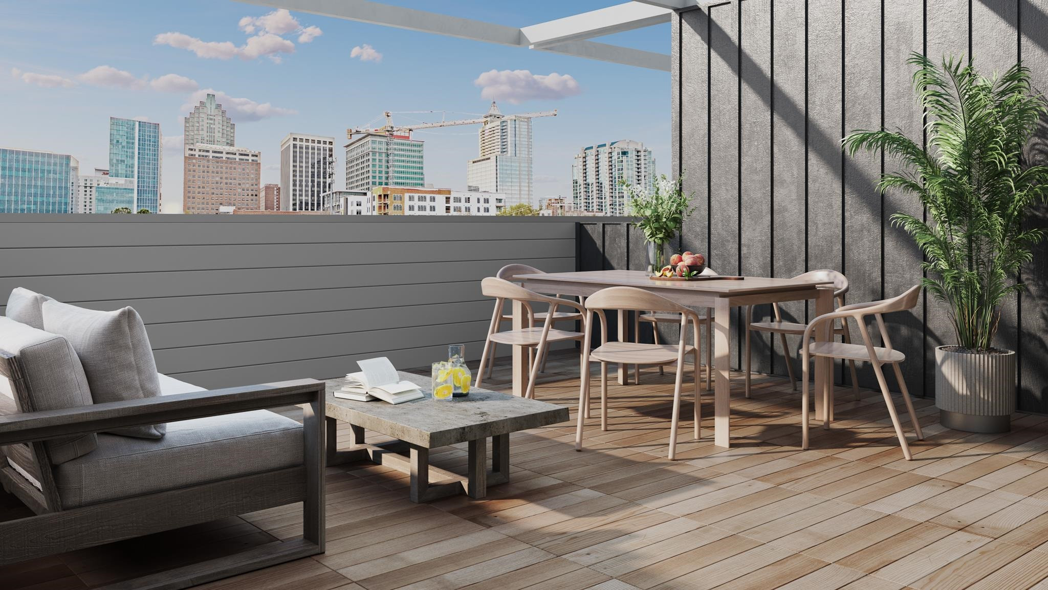 a roof deck with a table and chairs and potted plants with wooden floor