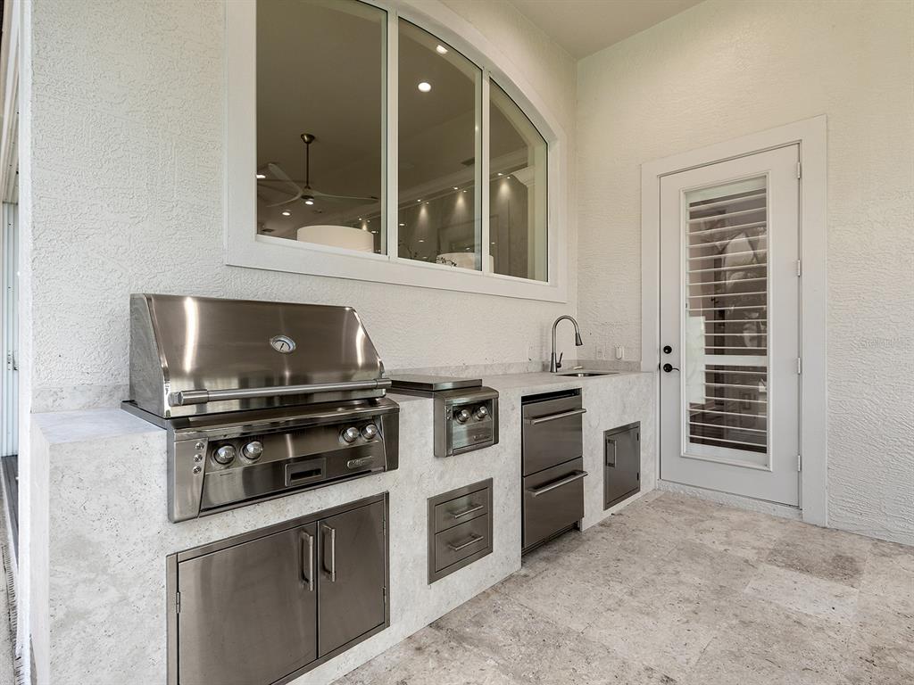7431 Greystone Street Lakewood Ranch, FL 34202 - Photo 56 of 85 a kitchen with stainless steel appliances a stove and a refrigerator