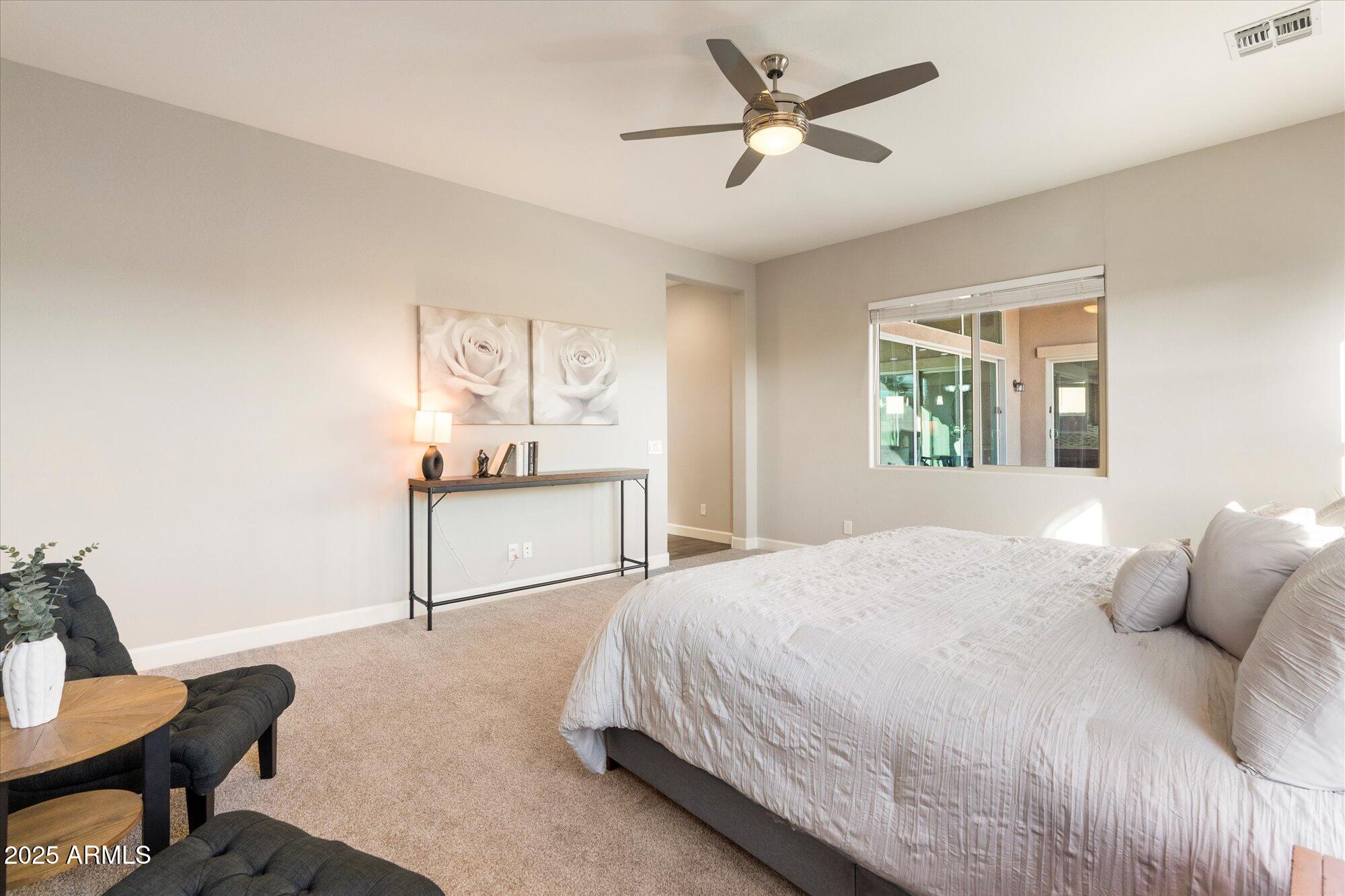 9275 West Plum Road Peoria, AZ 85383 - Photo 17 of 39 a bedroom with a bed and a window