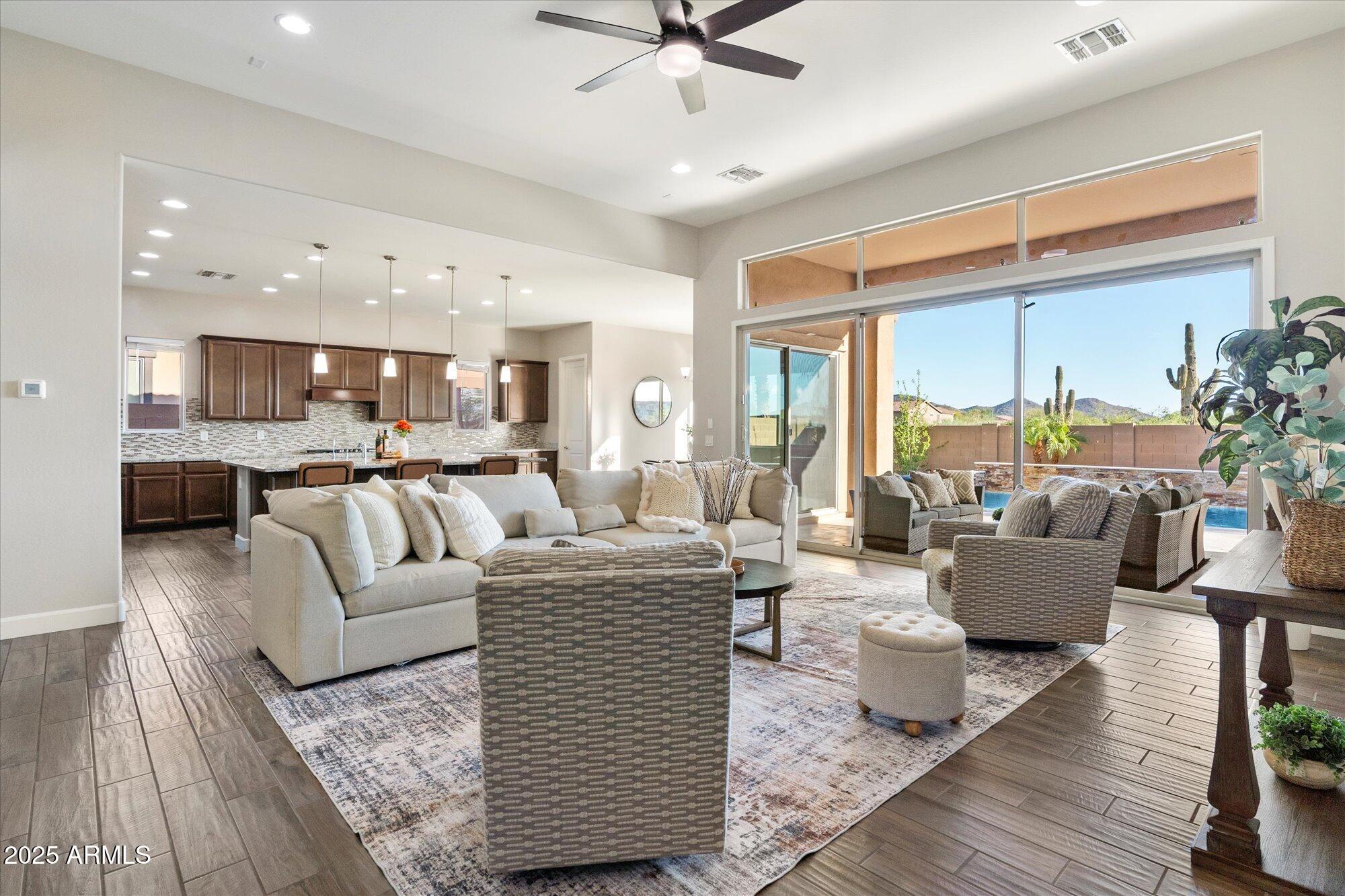 9275 West Plum Road Peoria, AZ 85383 - Photo 2 of 39 a living room with furniture and a large window