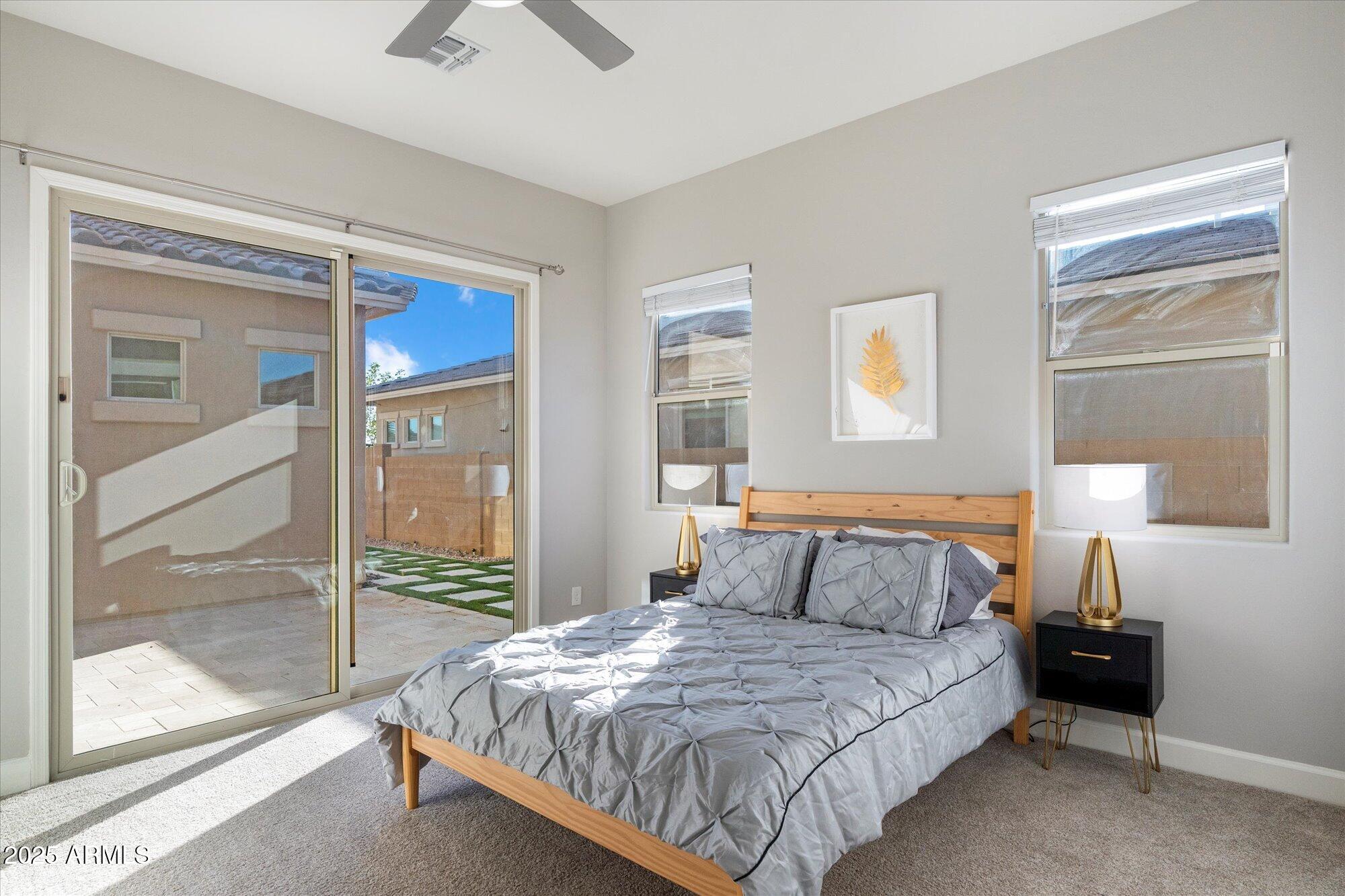 9275 West Plum Road Peoria, AZ 85383 - Photo 22 of 39 a bedroom with a bed and a night stand