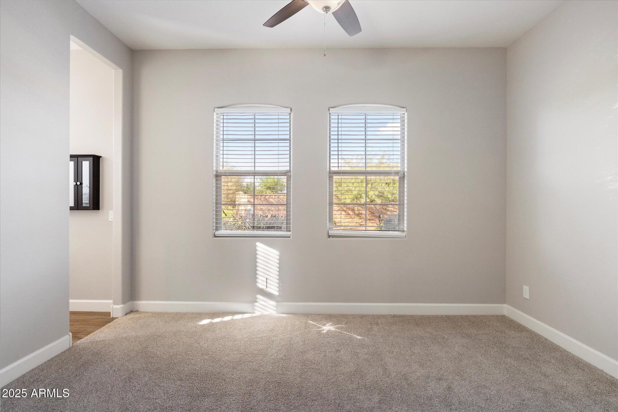 9275 West Plum Road Peoria, AZ 85383 - Photo 23 of 39 an empty room with windows