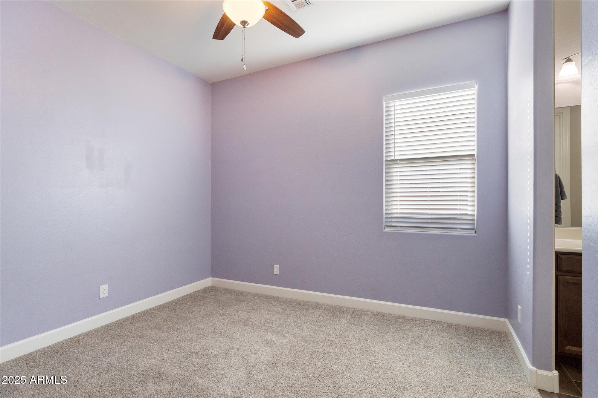 9275 West Plum Road Peoria, AZ 85383 - Photo 26 of 39 an empty room with a window and a fan