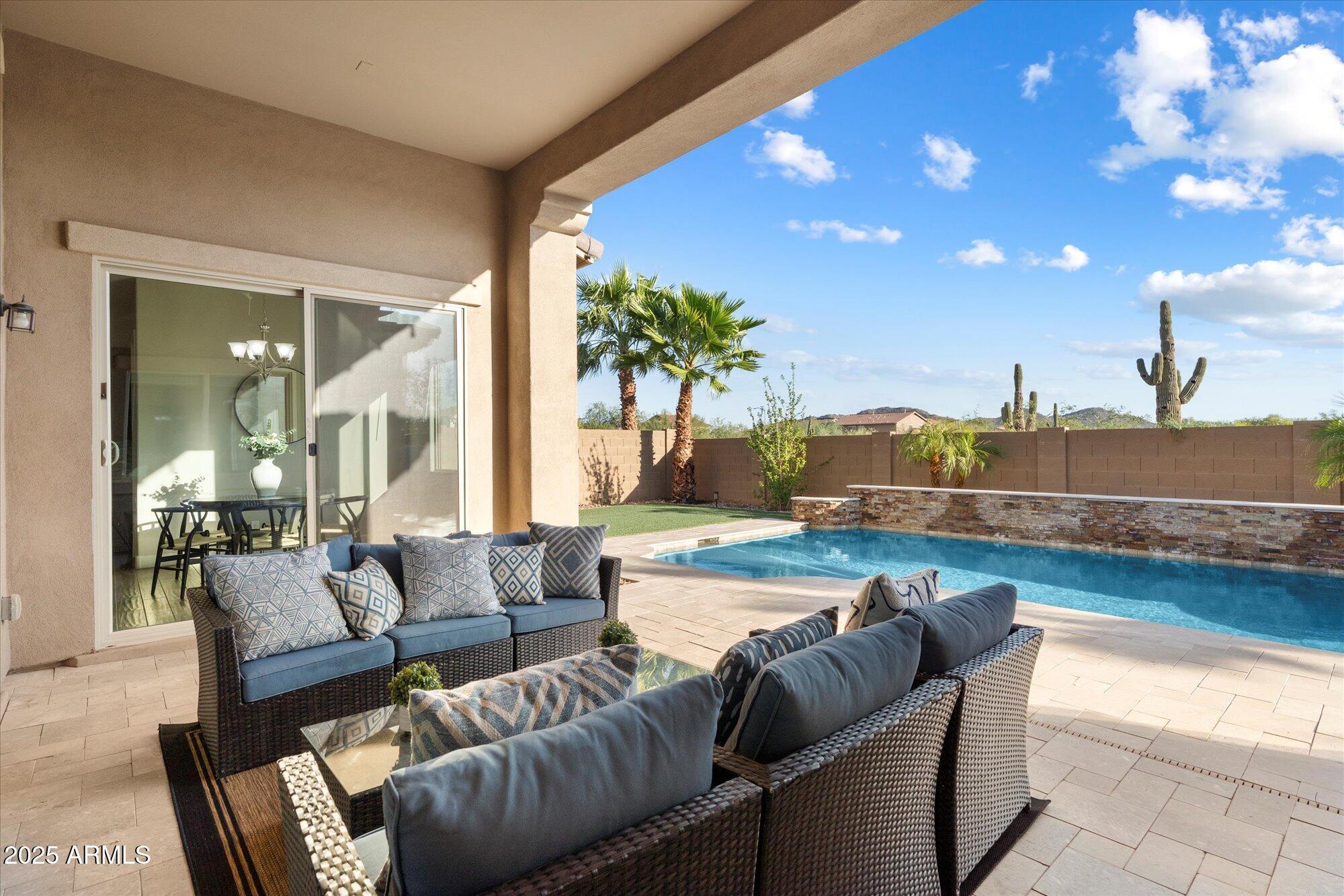 9275 West Plum Road Peoria, AZ 85383 - Photo 28 of 39 a living room with furniture and a floor to ceiling window