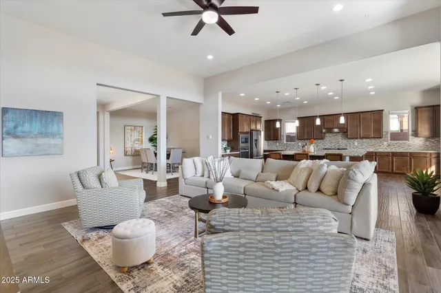 a living room with furniture and kitchen view