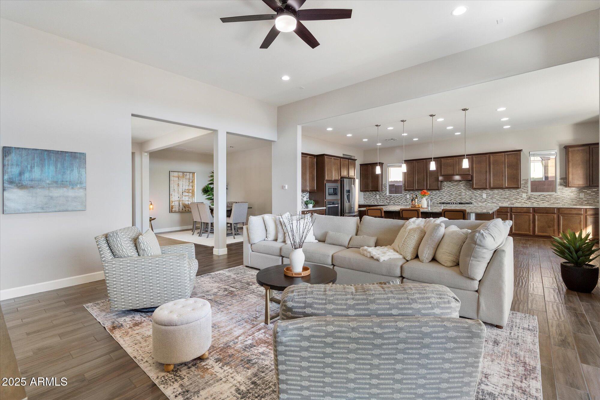 9275 West Plum Road Peoria, AZ 85383 - Photo 3 of 39 a living room with furniture and kitchen view