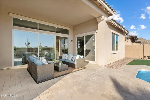 a view of a patio with couches and potted plants