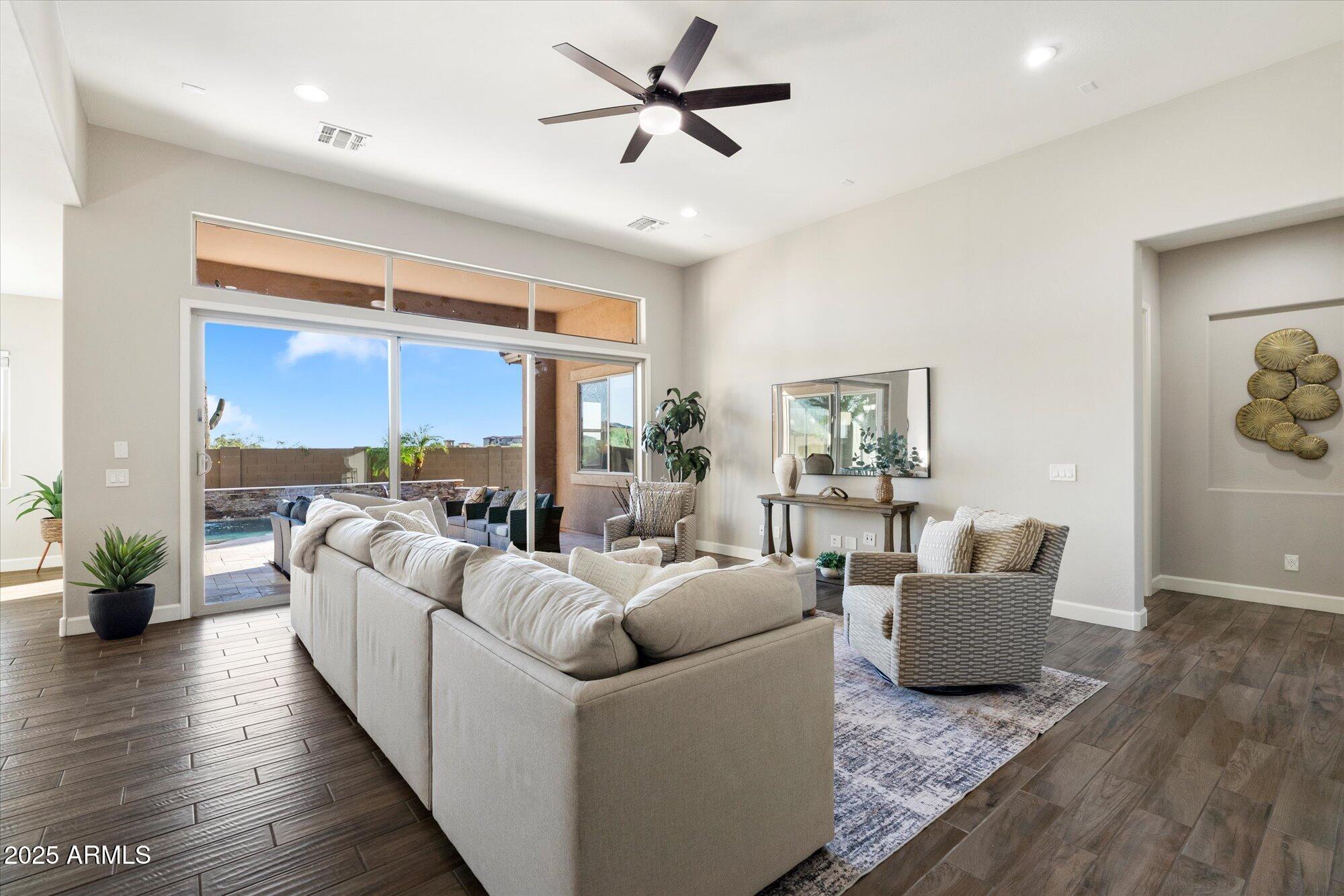 9275 West Plum Road Peoria, AZ 85383 - Photo 4 of 39 a living room with furniture and a large window