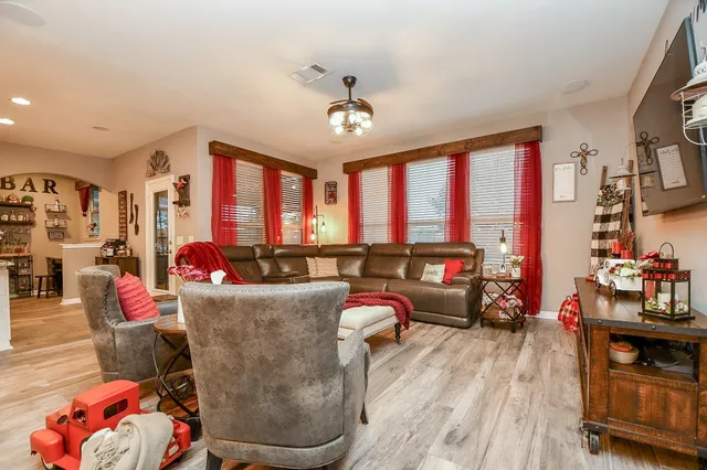 a living room with furniture and a floor to ceiling window