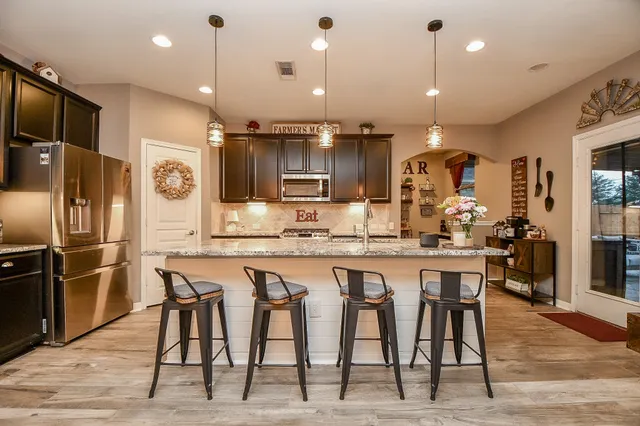 a large kitchen with a table and chairs