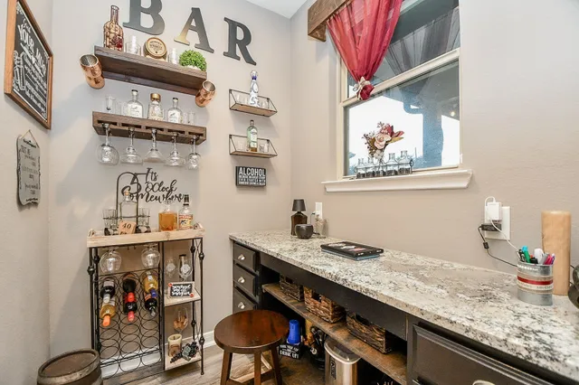 a bathroom with a granite countertop sink a stove and cabinets