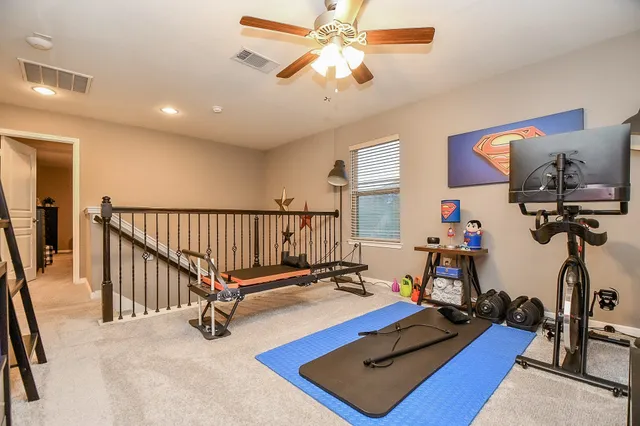 a room with gym equipment and a mirror