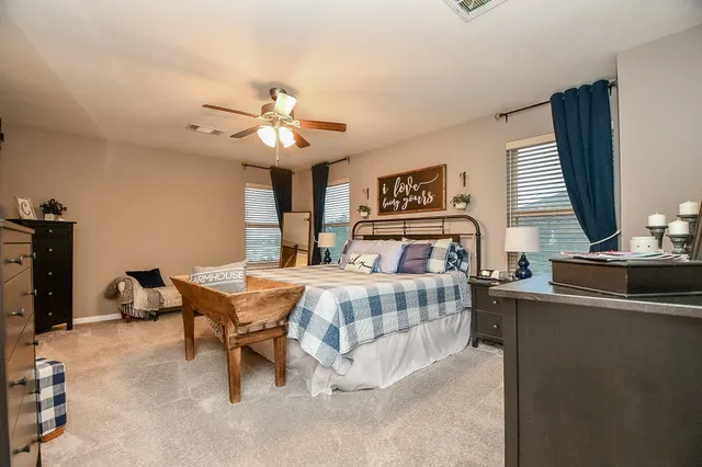 a bedroom with a bed and a chandelier