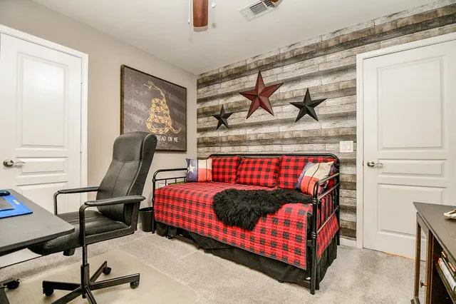 a bedroom with a bed and a chandelier