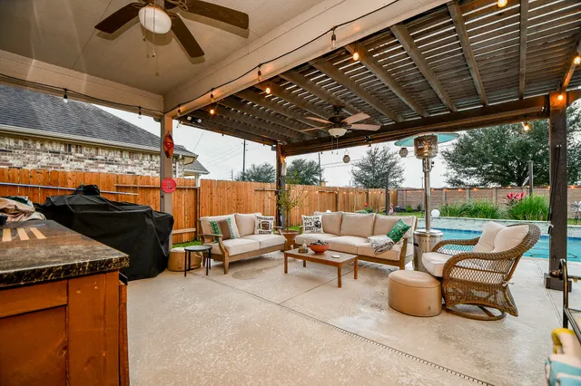 a outdoor sitting area with furniture and wooden floor