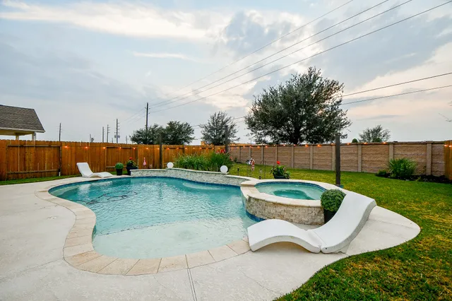 a view of a house with backyard porch and sitting area