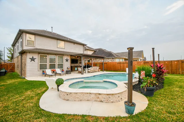 a view of a house with sitting area and garden