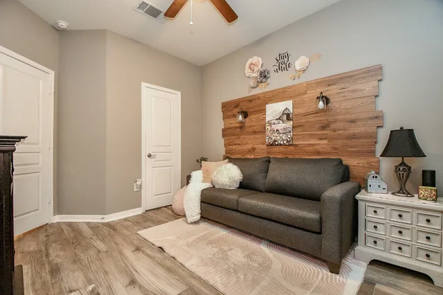 a bedroom with furniture and a flat screen tv