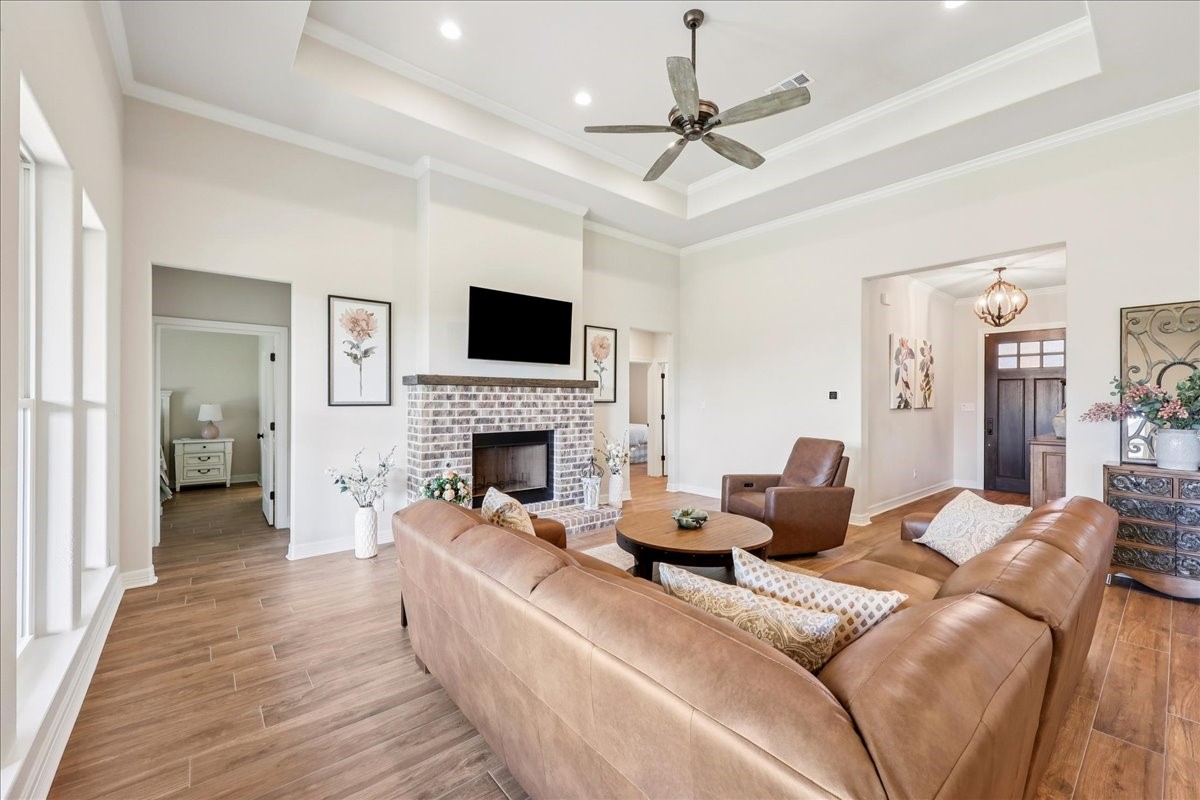 9205 Chicory Street Beaumont, TX 77713 - Photo 11 of 43 a living room with furniture a fireplace and a flat screen tv