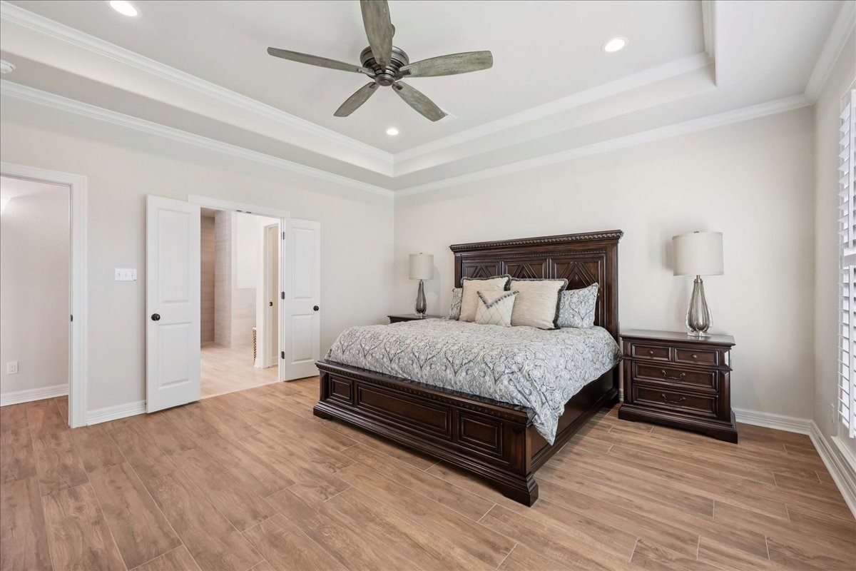 9205 Chicory Street Beaumont, TX 77713 - Photo 16 of 43 a bedroom with a bed and wooden floor