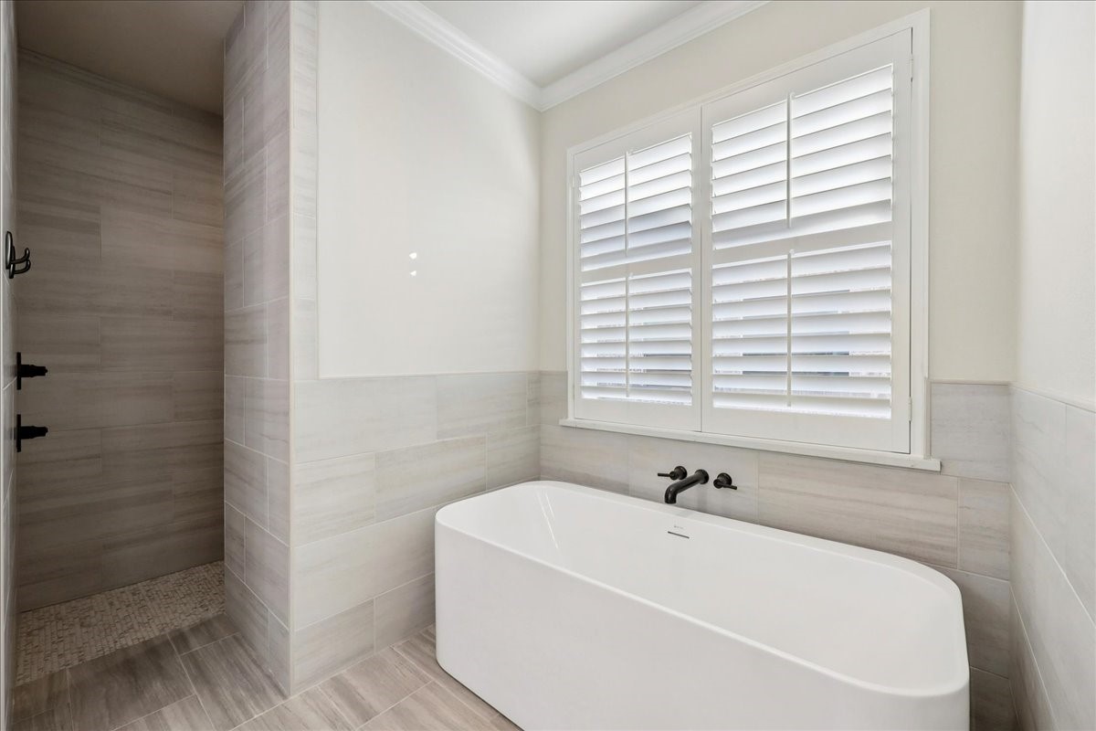 9205 Chicory Street Beaumont, TX 77713 - Photo 19 of 43 a white bath tub sitting in a bathroom next to a window