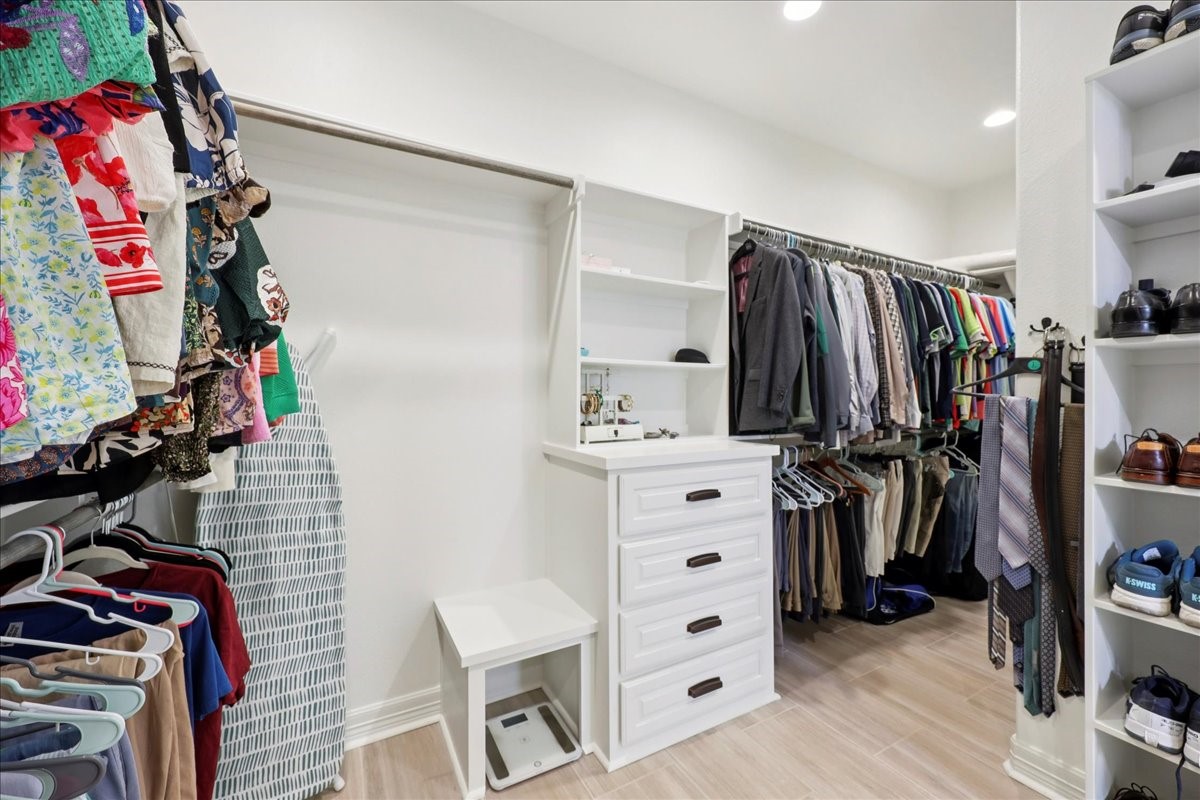 9205 Chicory Street Beaumont, TX 77713 - Photo 21 of 43 a view of walk in closet with clothes and shoes