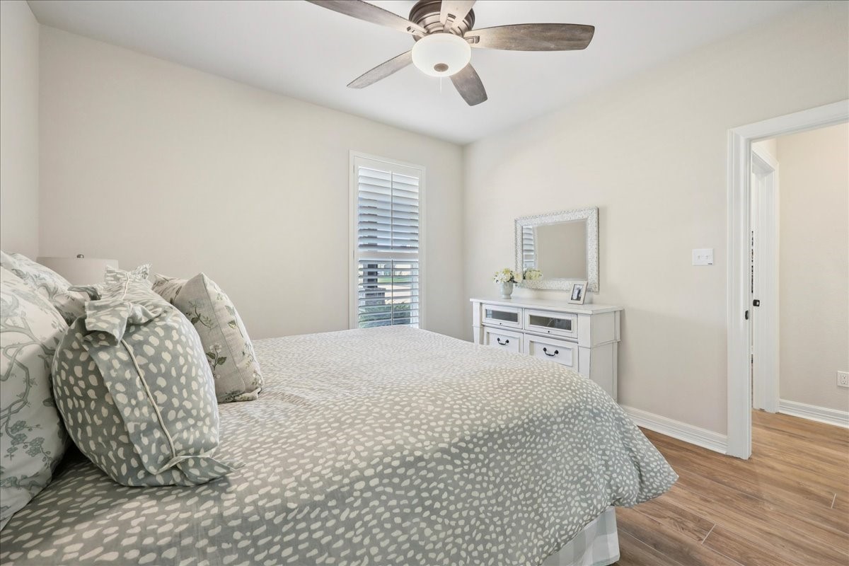 9205 Chicory Street Beaumont, TX 77713 - Photo 27 of 43 a bedroom with a bed and a chandelier