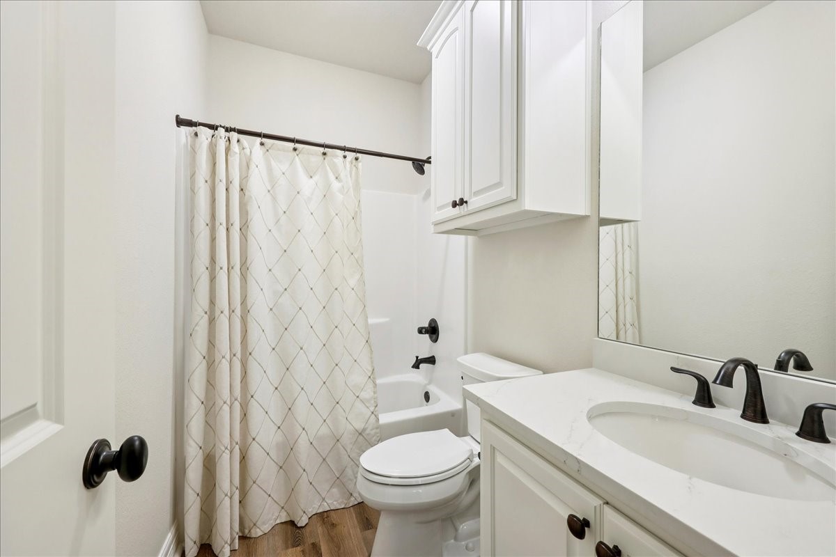 9205 Chicory Street Beaumont, TX 77713 - Photo 33 of 43 a bathroom with a granite countertop sink toilet and shower