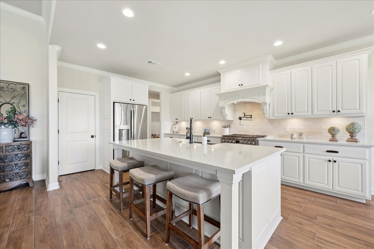 9205 Chicory Street Beaumont, TX 77713 - Photo 6 of 43 a kitchen with stainless steel appliances granite countertop a table chairs refrigerator sink and cabinets