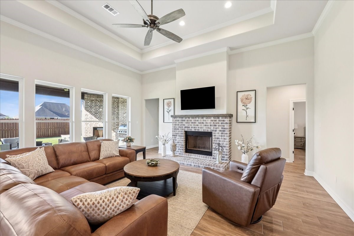 9205 Chicory Street Beaumont, TX 77713 - Photo 10 of 43 a living room with furniture a fireplace and a flat screen tv