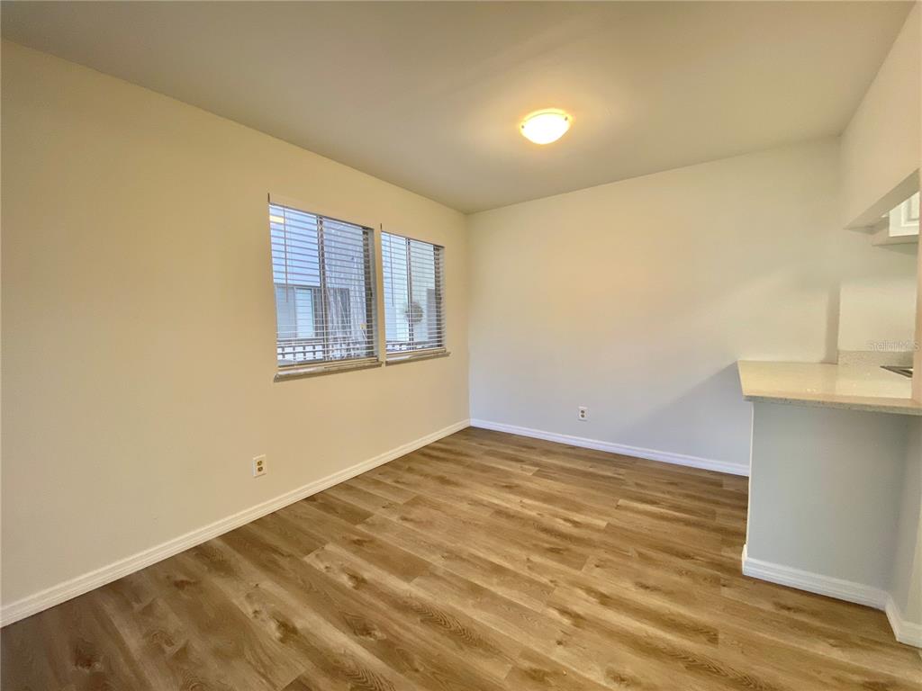 6519 West Newberry Road, Unit 1211 Gainesville, FL 32605 - Photo 5 of 10 a view of an empty room with wooden floor and a window