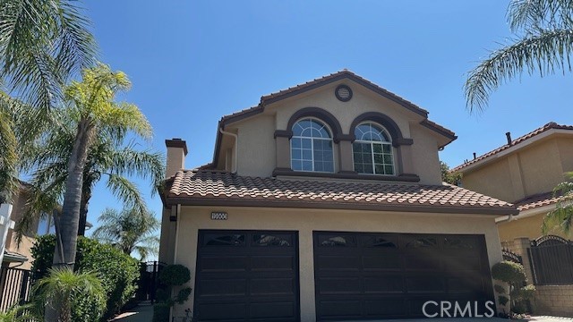 19900 Mariposa Creek Way Porter Ranch, CA 91326 - Photo 2 of 37 a front view of a house with a garage