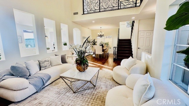 19900 Mariposa Creek Way Porter Ranch, CA 91326 - Photo 8 of 37 a living room with furniture potted plant and a large mirror