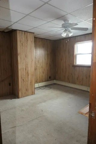 a view of a room with a wooden door