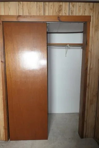 a view of a hallway and a livingroom with couch