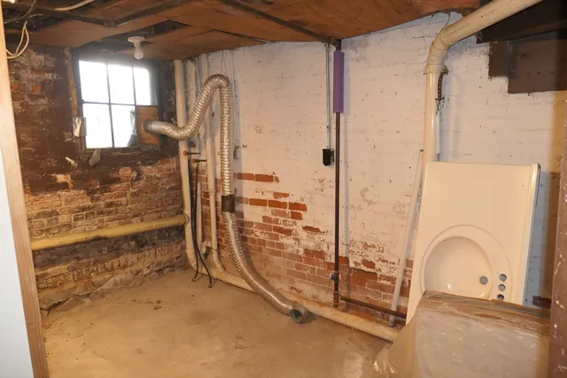 a view of a room with wooden floor and windows