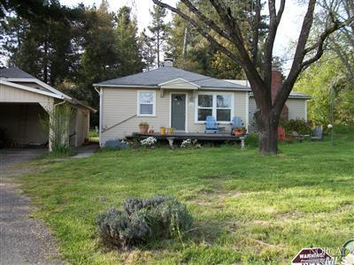 9086 Green Valley Road Sebastopol, CA 95472 - Photo 1 of 1 a front view of a house with a garden and trees