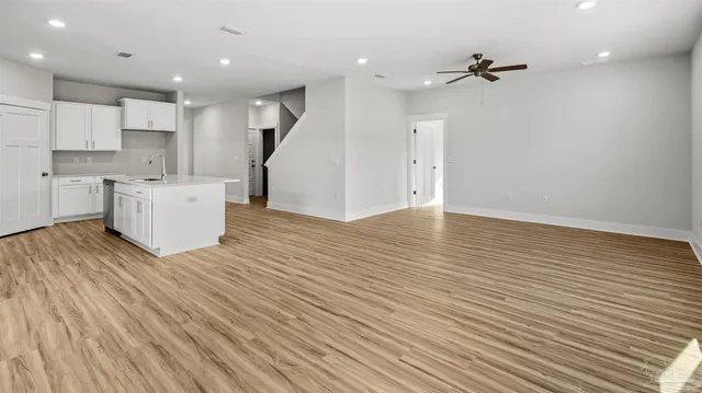 a view of a kitchen with furniture and wooden floor