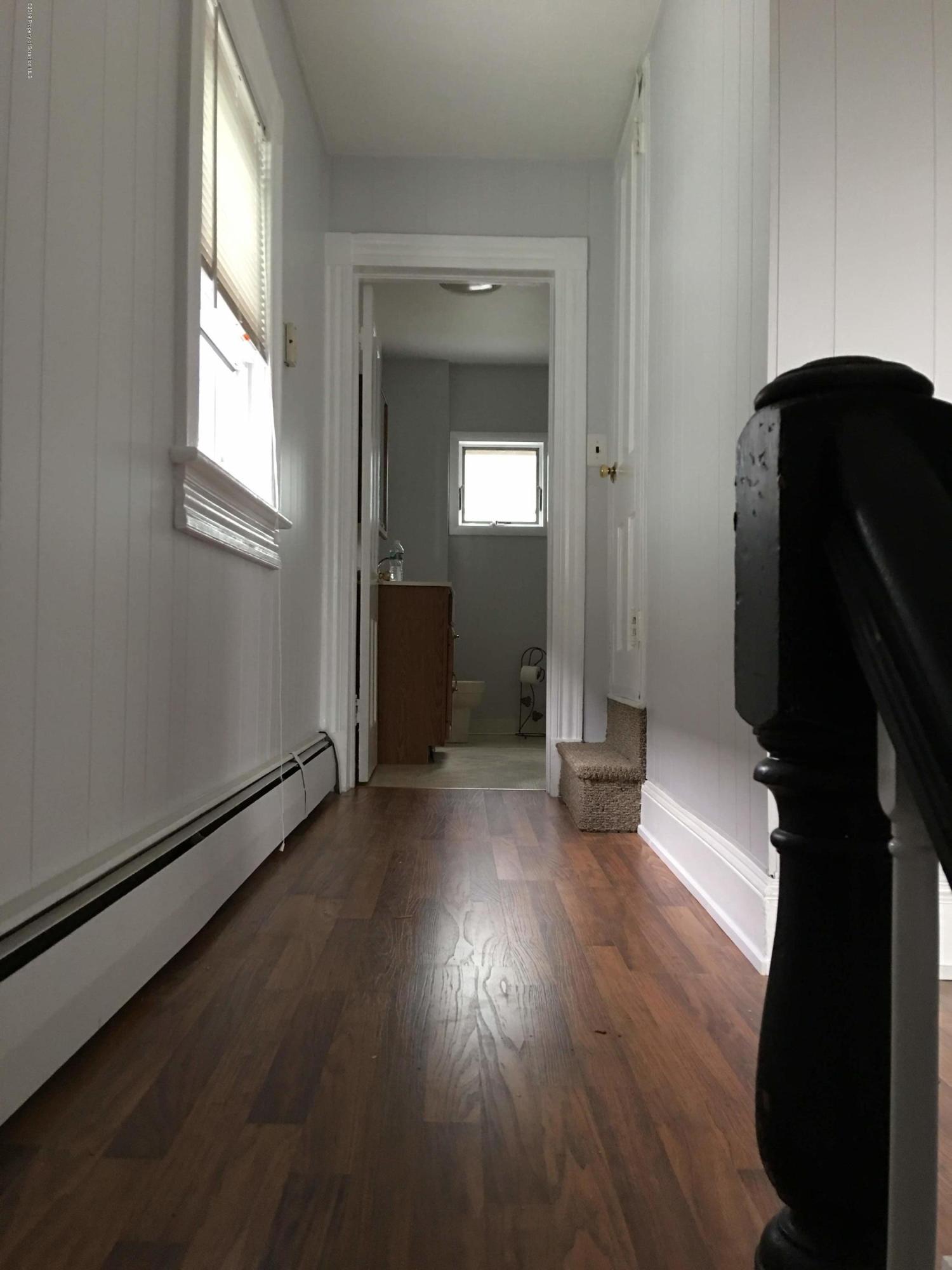 1519 Pine Street Scranton, PA 18510 - Photo 11 of 13 an empty room with wooden floor and windows