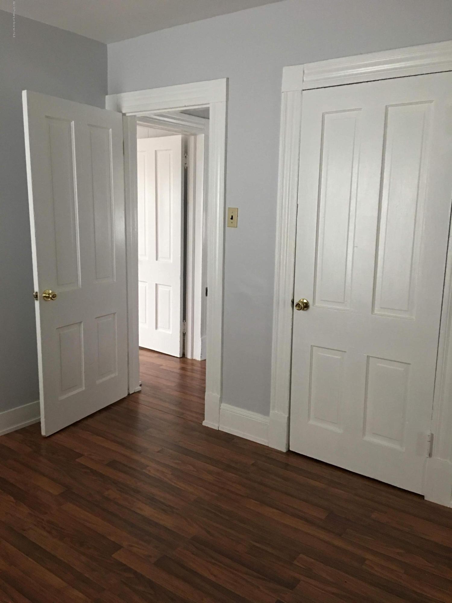 1519 Pine Street Scranton, PA 18510 - Photo 13 of 13 an empty room with wooden floor and closet area
