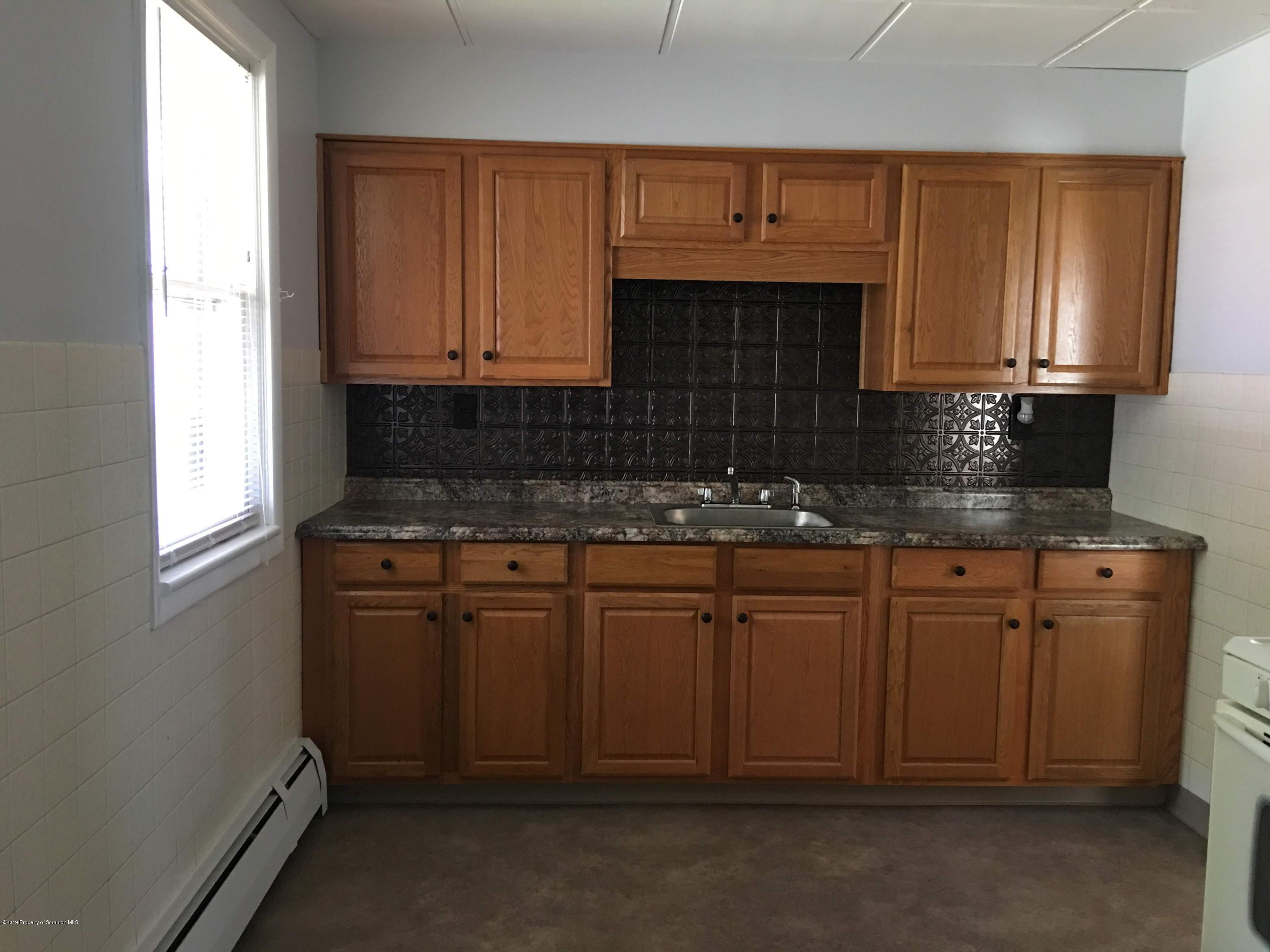 1519 Pine Street Scranton, PA 18510 - Photo 2 of 13 a kitchen with granite countertop cabinets stainless steel appliances a sink and a window