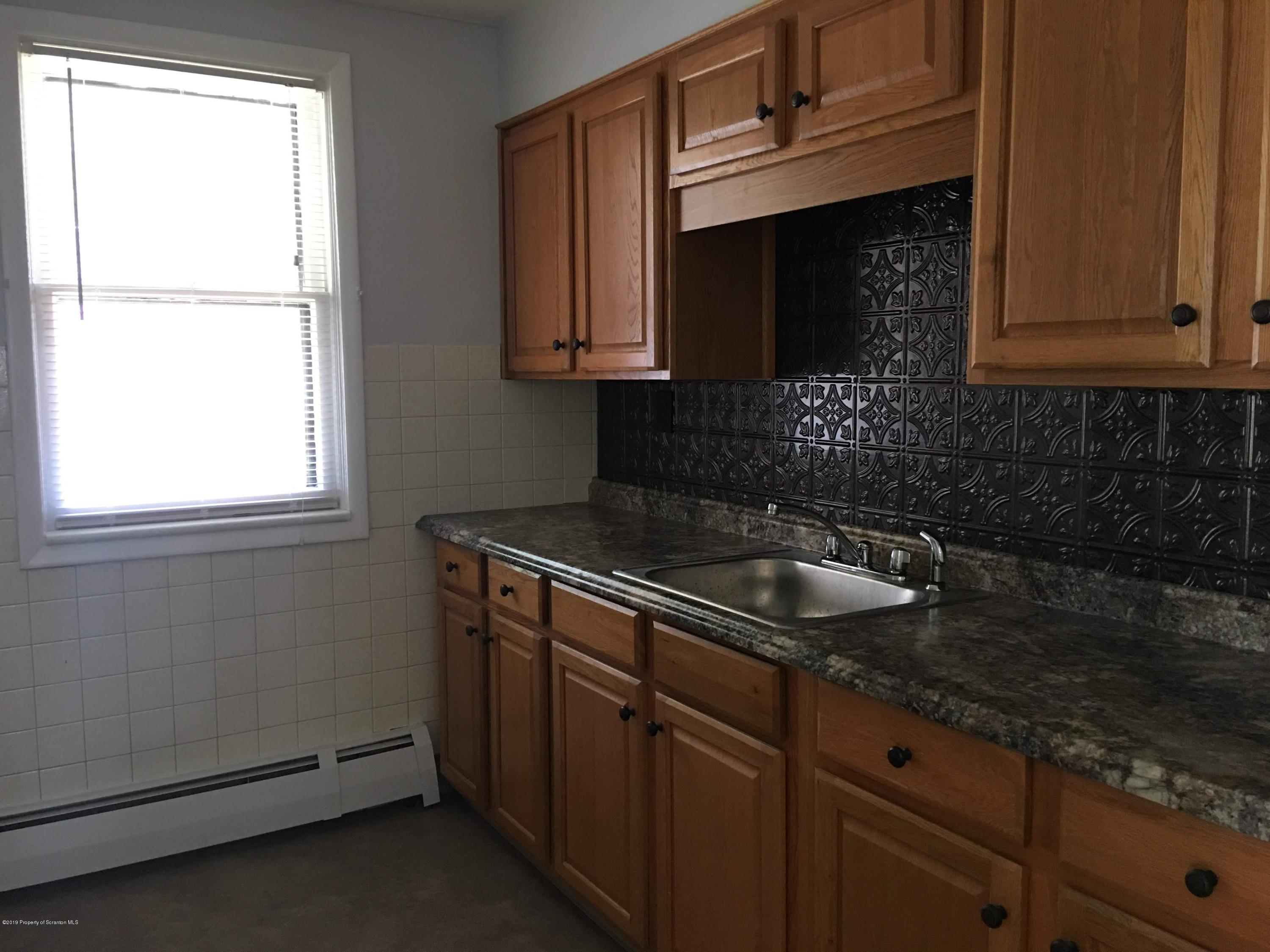 1519 Pine Street Scranton, PA 18510 - Photo 3 of 13 a kitchen with sink a microwave and cabinets
