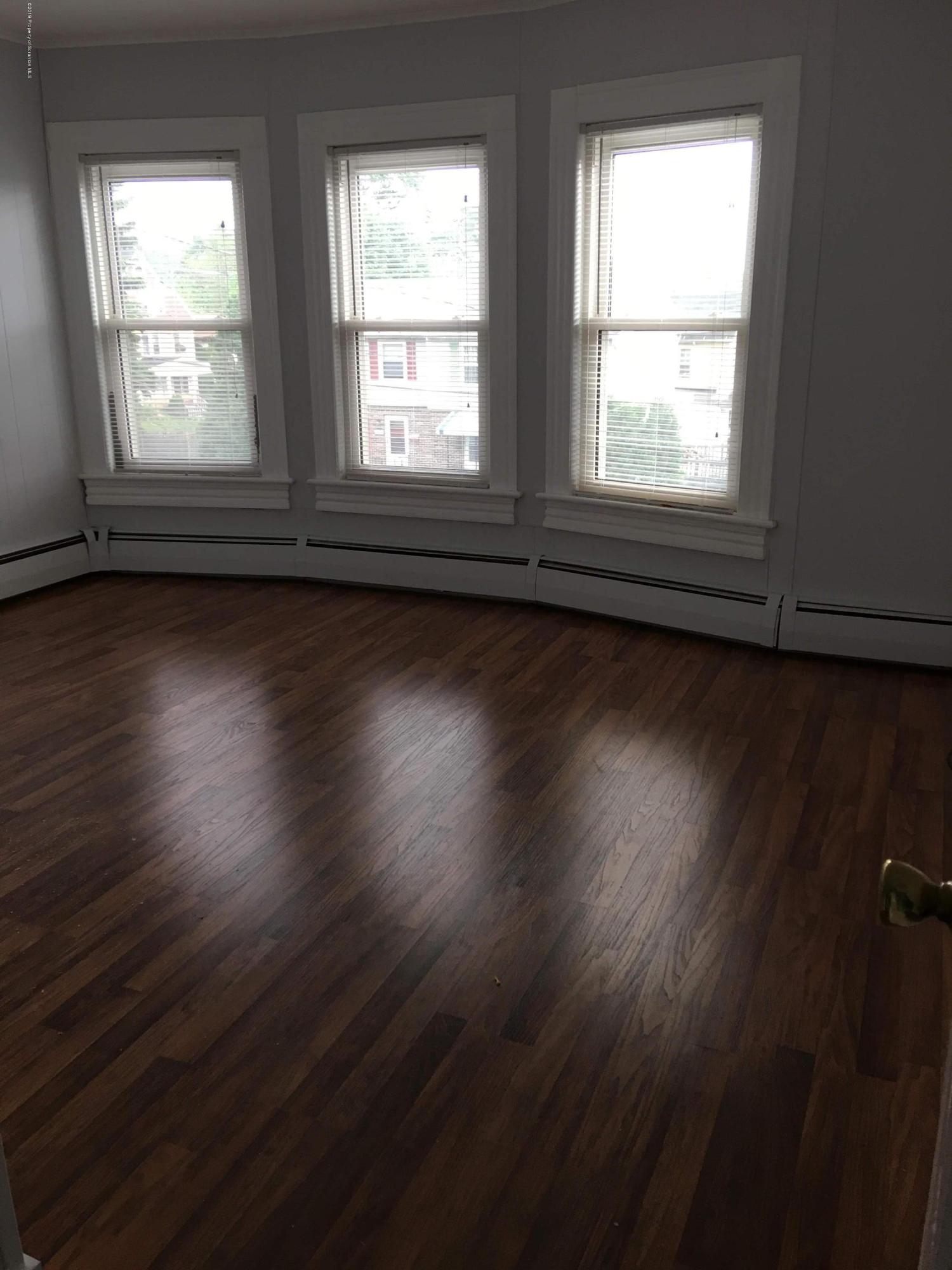 1519 Pine Street Scranton, PA 18510 - Photo 6 of 13 an empty room with wooden floor and windows