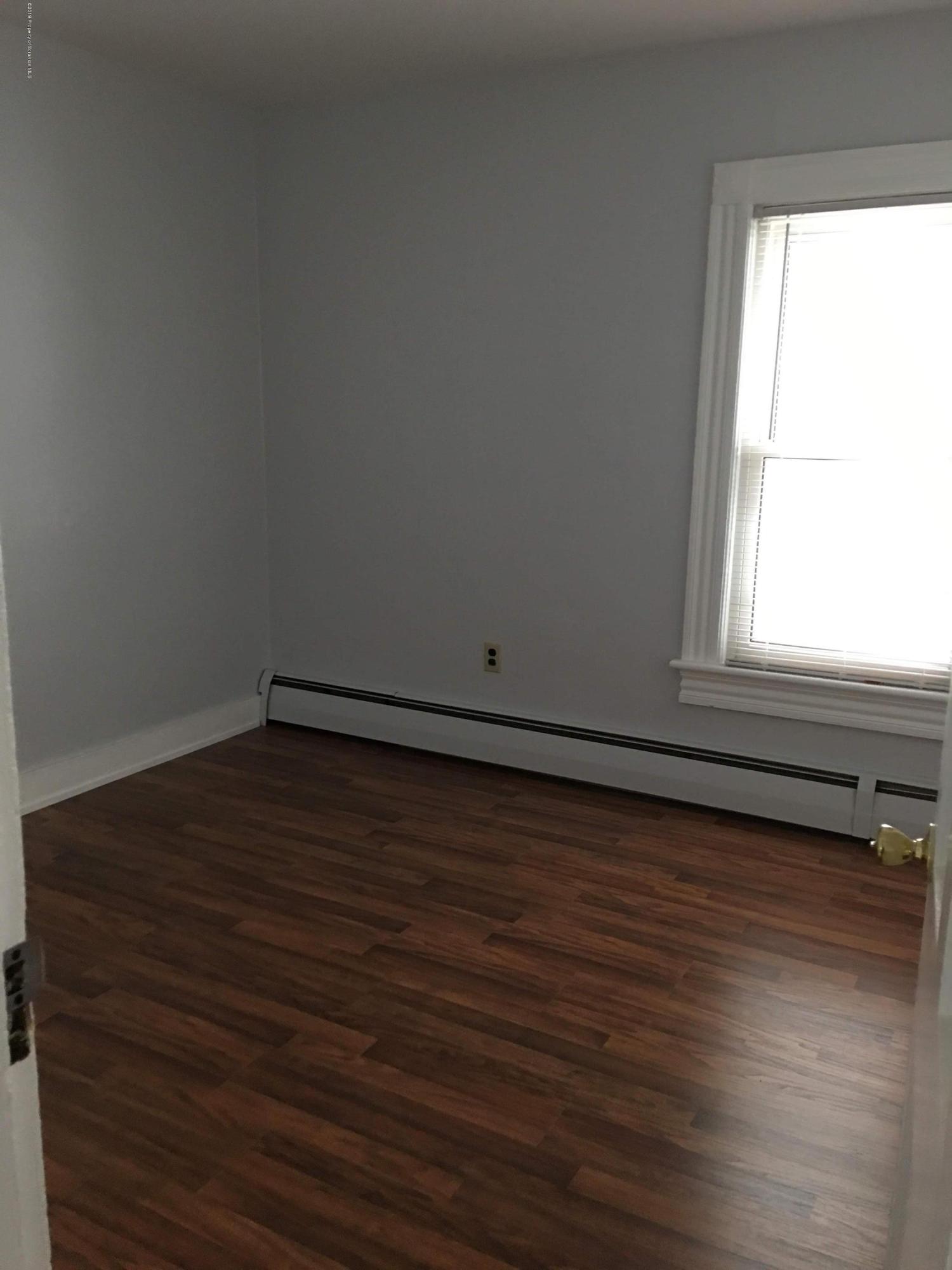 1519 Pine Street Scranton, PA 18510 - Photo 9 of 13 a view of a room with wooden floor and a window