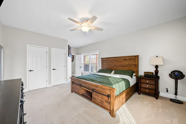 a bed room with a bed and a chair