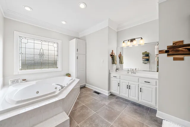 a bedroom with a bed couch and a flat screen tv