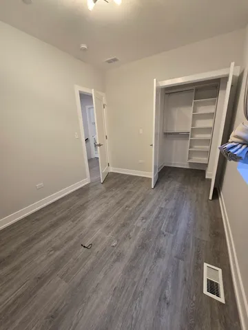 wooden floor in an empty room with a closet