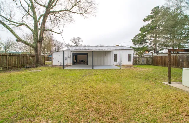 a front view of house with yard and swimming pool