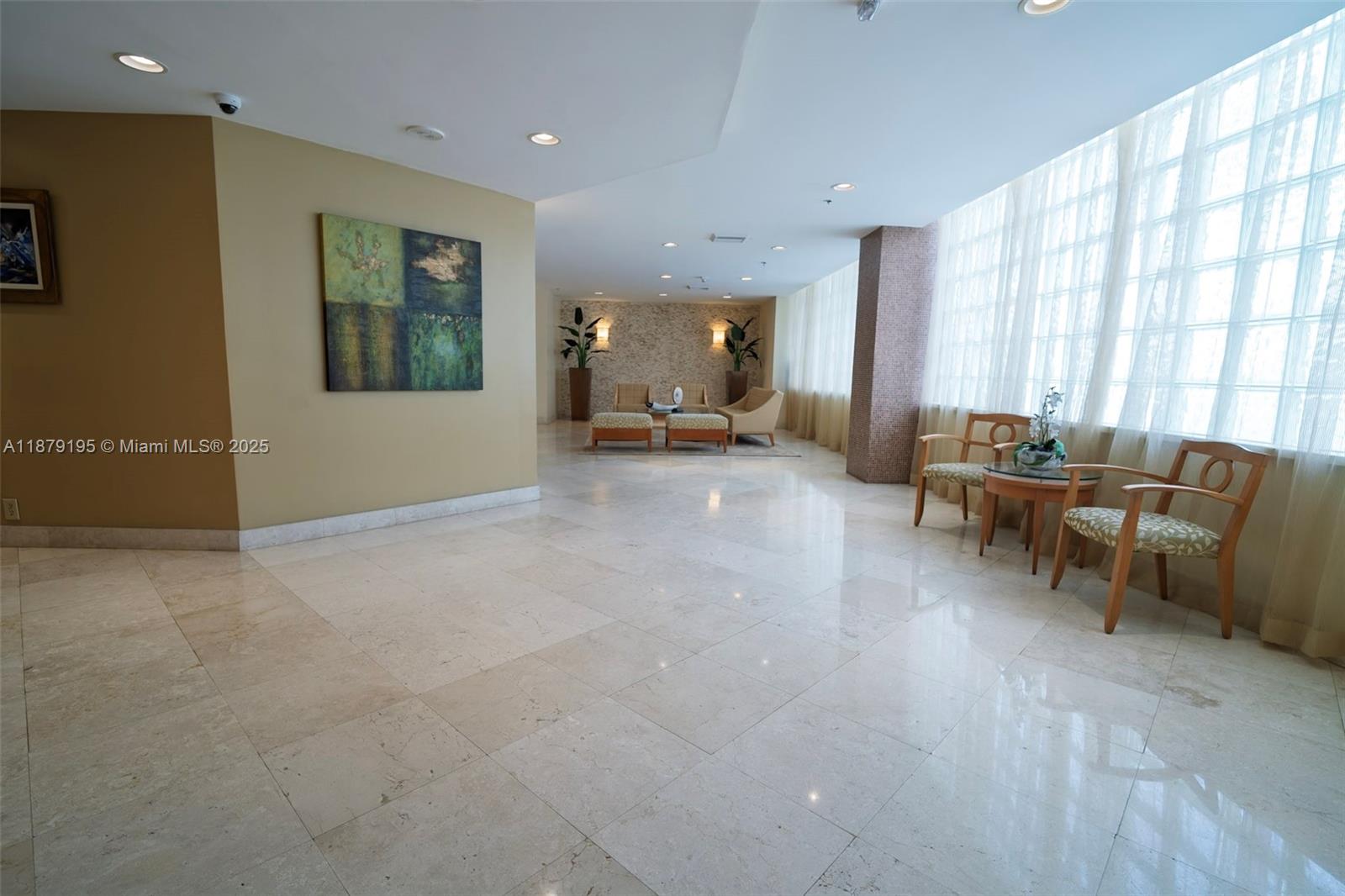 6767 Collins Avenue, Unit 401 Miami Beach, FL 33141 - Photo 18 of 19 a living room with furniture and large windows